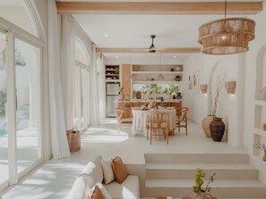 A modern interior with a dining area, kitchen, and living space.