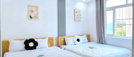 Quadruple Room, Balcony | Minibar, individually furnished, desk, blackout drapes