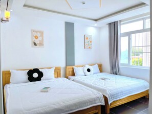 Quadruple Room, Balcony | Minibar, individually furnished, desk, blackout curtains - Hà Đan Hotel - Bãi Sau Vũng Tàu (Vũng Tàu)