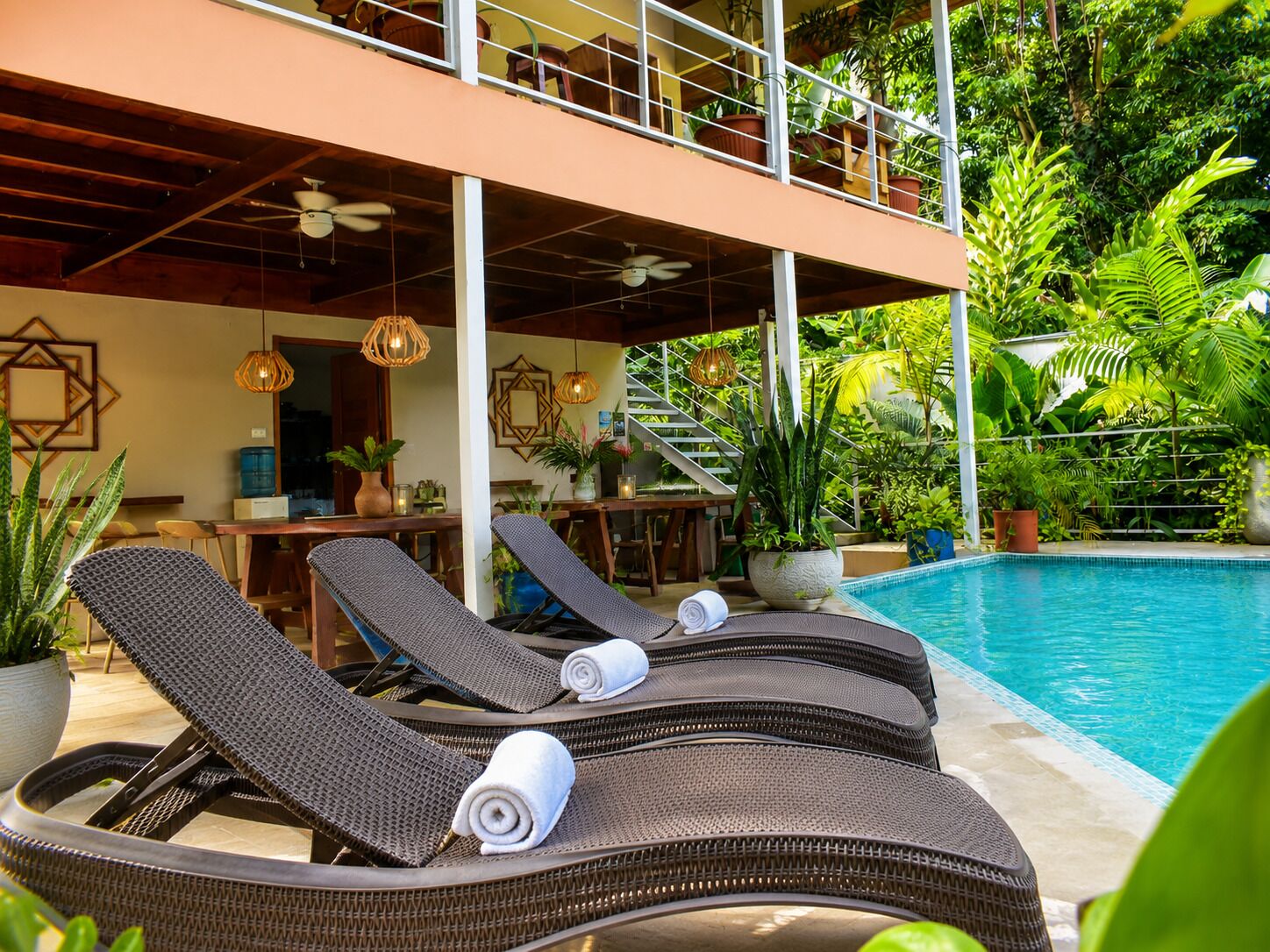 A poolside area with lounge chairs and a pool.