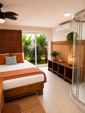 Un dormitorio con cama, ventilador de techo, cabina de ducha de vidrio y vistas al exterior.