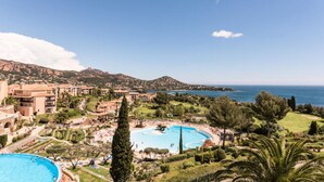 A resort with a large swimming pool, multiple buildings, and a view of the sea. - 2 Room Apartment 5 People - Selection (Saint-Raphael)