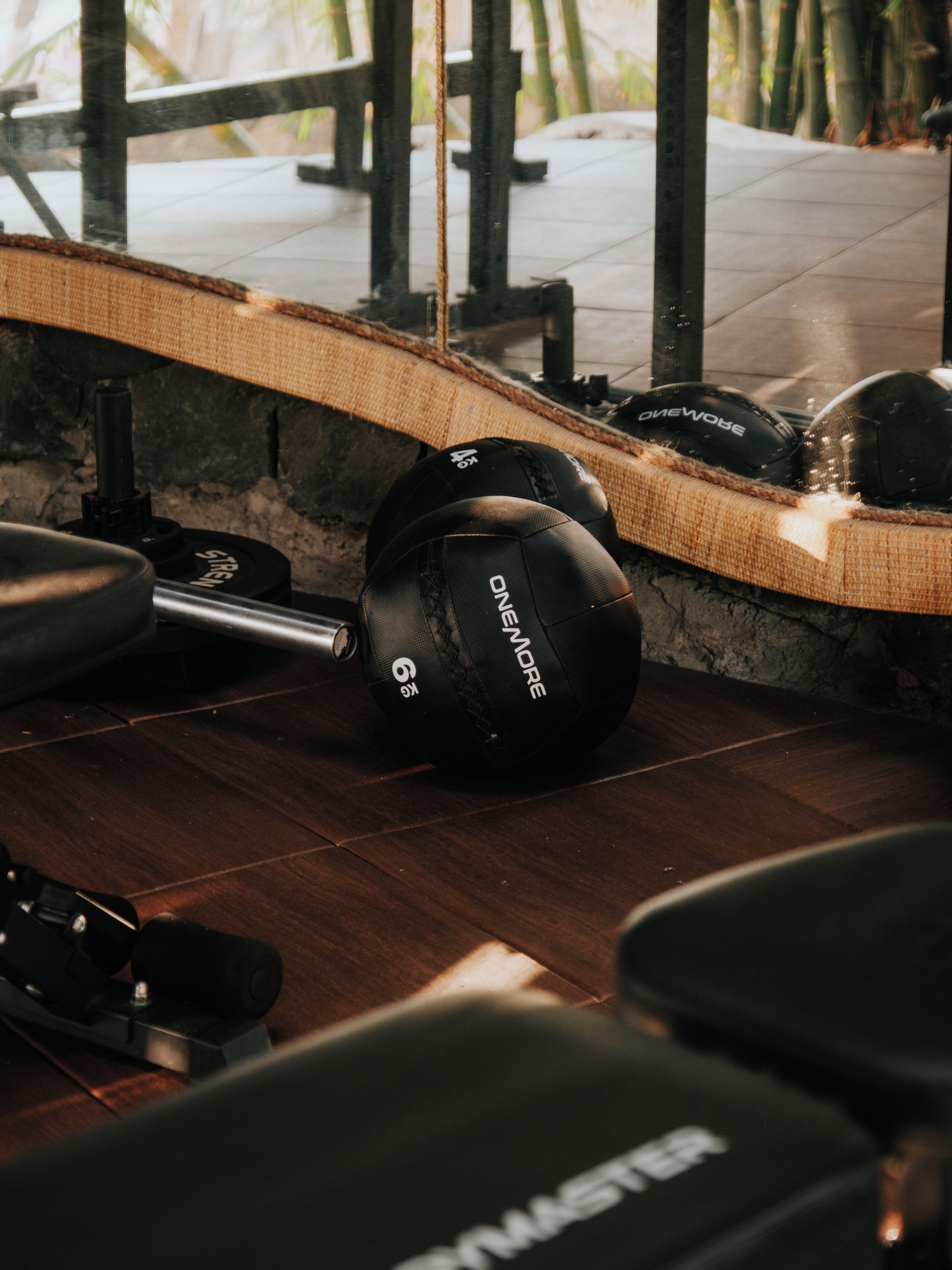 A weightlifting area with kettlebells, a barbell, and weight plates.