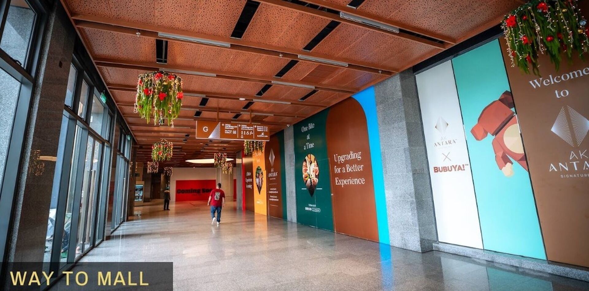A corridor with directional signs, a 'Way to Mall' sign, and a 'Welcome to Antara' sign.