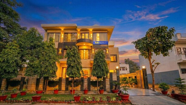 A modern hotel with a two-story structure, featuring a prominent 'fab hotels' sign. - Fabhotel Smart Inn-1 (Gurugram)