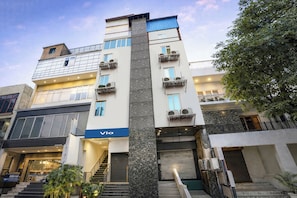 A multi-story building with a prominent 'Via' sign, a staircase leading to the entrance, and air conditioning units on the exterior. - Via Anand Mukesh Residency - Greater Kailash (New Delhi)