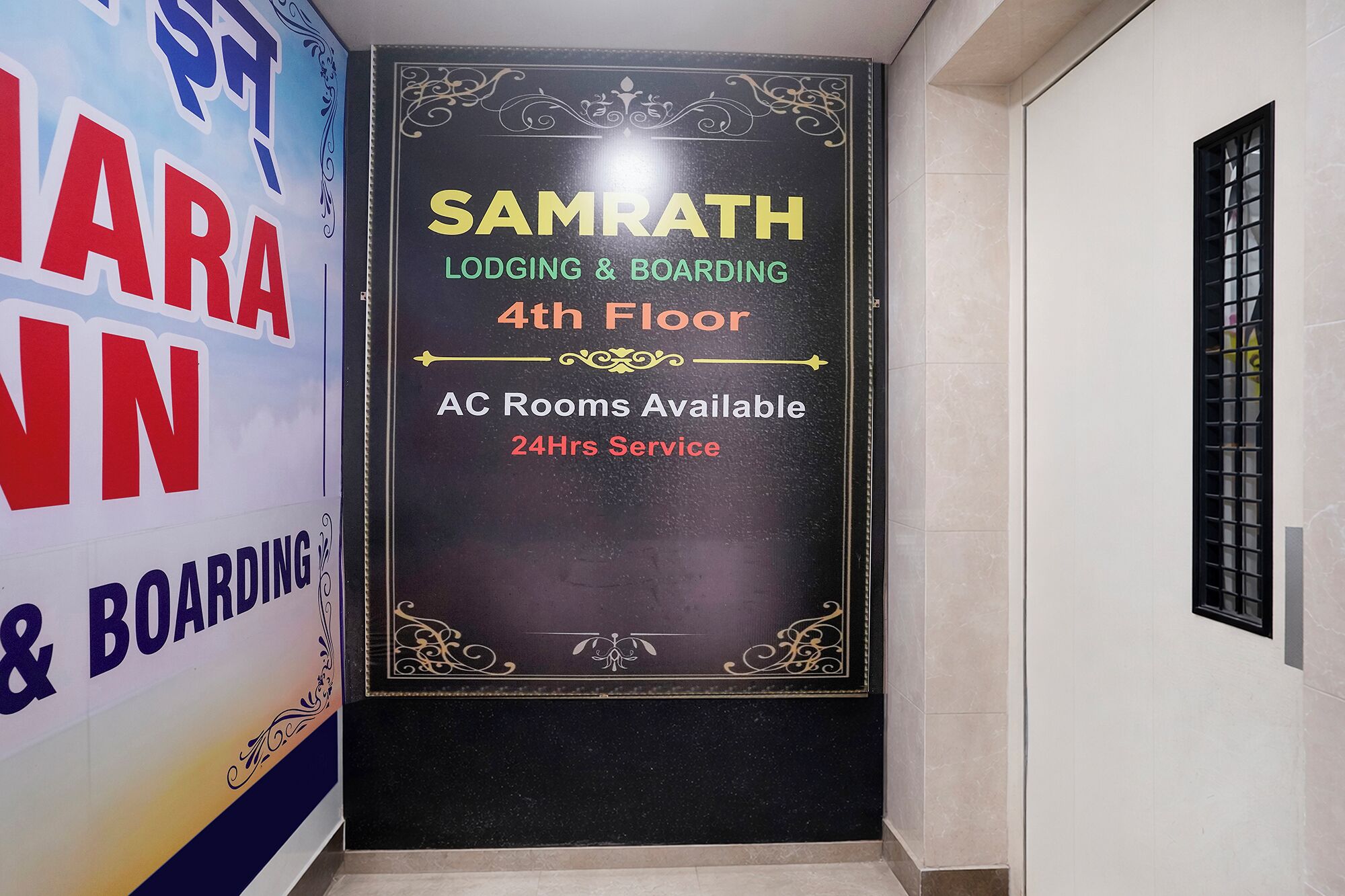 A sign for Samrath Lodging & Boarding on the 4th floor with AC rooms available and 24-hour service.