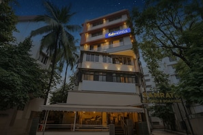 A multi-story building with a 'fabHOTELS' sign, a 'SAMRAT' sign, and a 'Lodging & Boarding' sign. - Fabhotel Samrath (Mumbai)