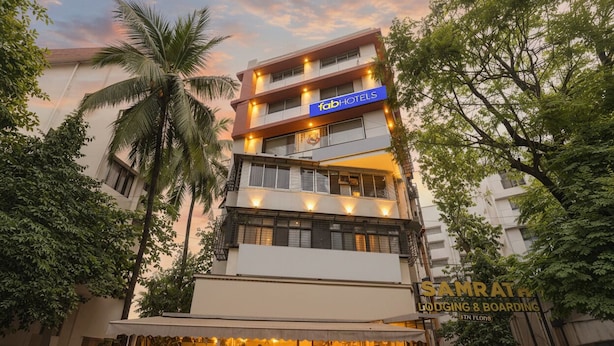 A multi-story building with a sign for 'fabHOTELS' and 'SAMRATH LODGING & BOARDING'. - Fabhotel Samrath (Mumbai)