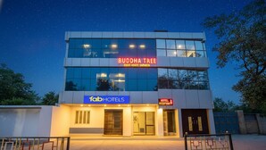 Ein modernes Gebäude mit einem Schild für „Buddha Tree Guest House Barnath“ und Branding von „Fab Hotels“.