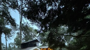 A two-story house with a balcony, a covered patio, and a staircase leading to the upper floor. - The Vintage Haven Munnar (Udumbanchola)