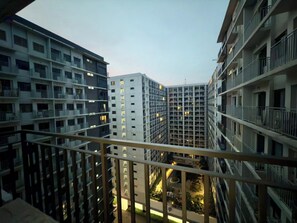 A high-rise residential building with multiple balconies and a central courtyard. - Ella’s Haven @ Shore 3 Residences • 2BR Walk to MOA • Minutes from NAIA (Pasay City)