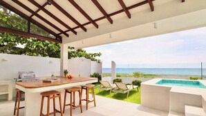 A covered outdoor area with a bar, seating, and a pool. - Alesea Baroro: Private Beachfront Villa - Pool, Jacuzzi (Bacnotan)