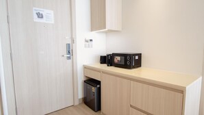 A compact kitchenette with a microwave, a small refrigerator, and a cabinet. - 2314 1BR Wyndham Naithon (Sa Khu)