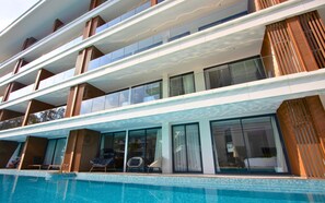 A multi-story hotel with a pool area, balconies, and large windows. - 189/222 3BR Beachfront Luxe Pool Access (Choeng Thale)
