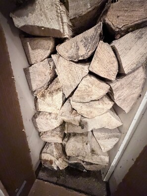 A stack of firewood in a corner.