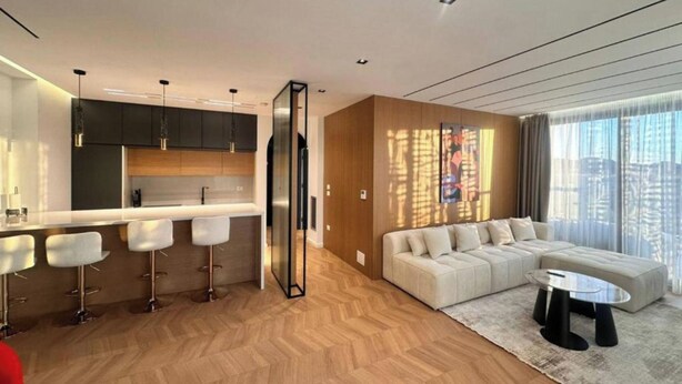 A modern living space with a kitchen, a dining area, and a seating area with a sofa and a coffee table. - City Centre Penthouse  (Tirana)