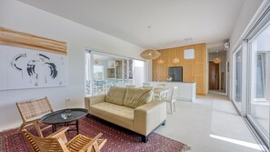 A modern living room with a sofa, a dining area, and a kitchen. - Villa Menta 4 by Villas Guide (Malinska)