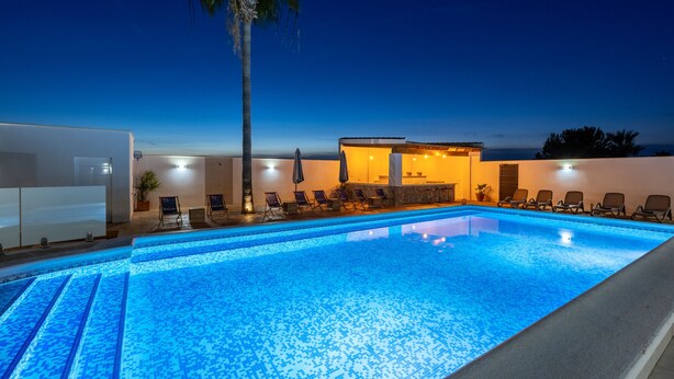 A swimming pool with lounge chairs and a small building with a tiled roof. - Psicomagia Deluxe Villa by Fidalsa (Dolores)