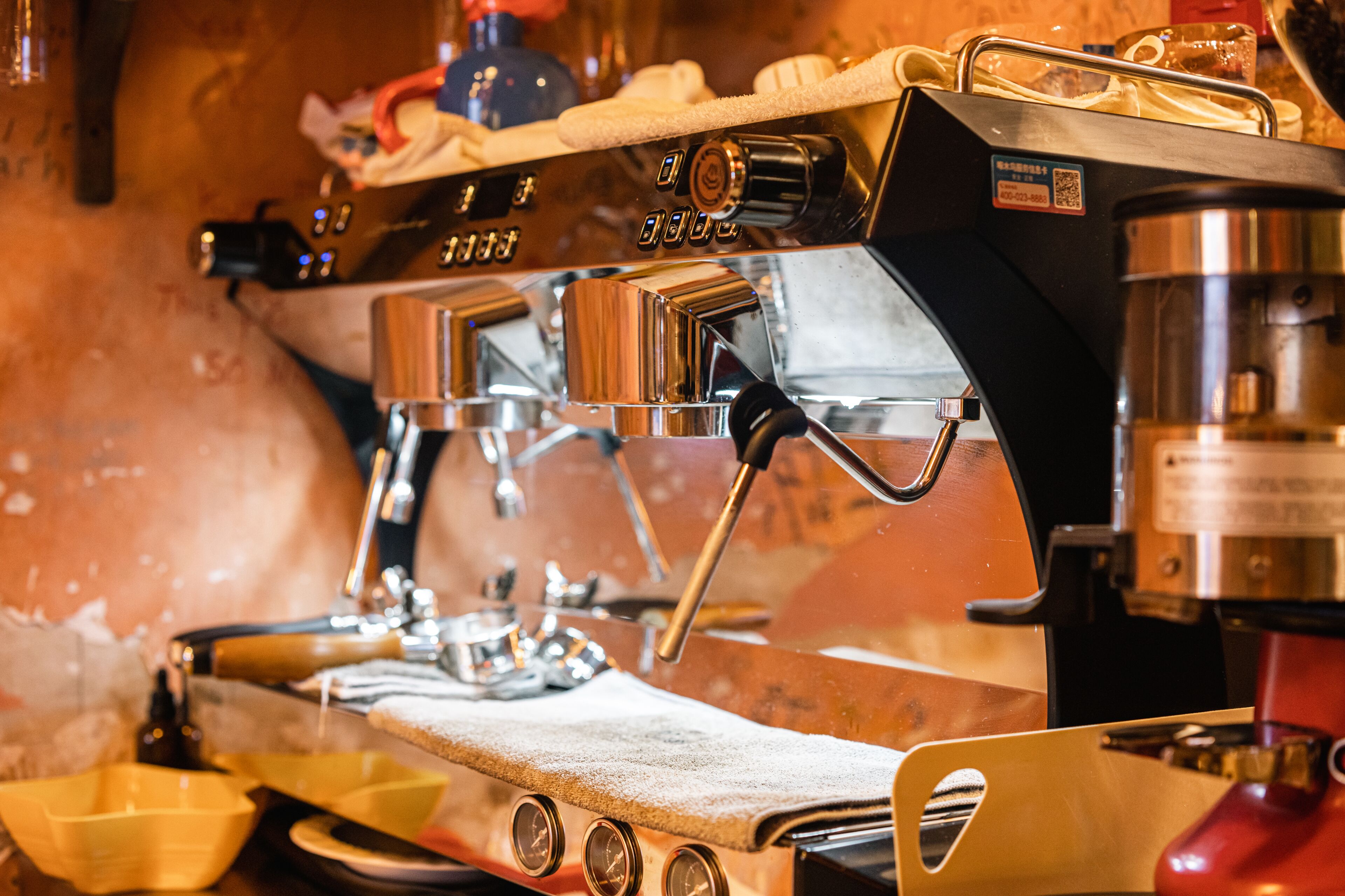 A coffee machine with a digital display, steam wand, and portafilter.