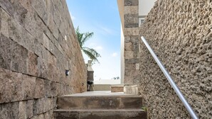 A stone staircase leading to a rooftop terrace with a view of the sky and palm trees. - Private Villa with Pool - Close to the Beach (Costa Adeje)