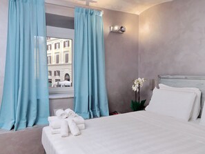 Deluxe Quadruple Room | Minibar, in-room safe, desk, free cribs/infant beds