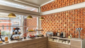 A breakfast bar with a brick wall, wooden cabinets, and a coffee machine. - Bob W Rome Testaccio (Rome)