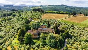 An aerial view of a countryside estate with olive groves, a central building with a tiled roof, and surrounding fields. - Villa Bartolini Baldelli - Authentic XV century villa with garden and pool (Toscana)