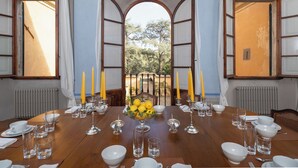 A dining table set for a meal with a view of trees through open doors. - Villa Bartolini Baldelli - Authentic XV century villa with garden and pool (Toscana)