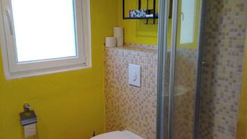 Shower, hair dryer, soap, toilet paper