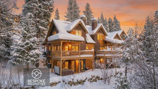 A large, multi-story lodge with a wooden exterior and multiple balconies, surrounded by snow-covered trees. - Ski in/out to Tamarack Express Chairlift, pet-friendly, AC, hot tub (Tamarack)