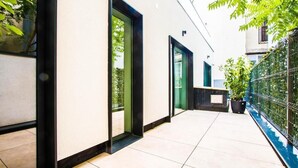 A modern building with a clean, white exterior, large glass doors, and a tiled floor. - Central Carol APARTHOTEL (Bucharest)