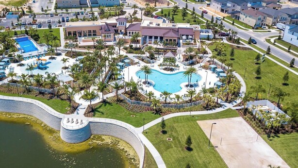 An aerial view of a resort with a central swimming pool, multiple buildings, and landscaped areas. - 5Bd Villa Private Pool Spa at Solara Resort 1820 (Kissimmee)