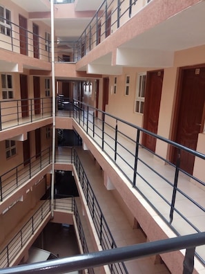 A multi-level building with balconies and railings. - Amara Ridge Hotel Meru  (Meru)