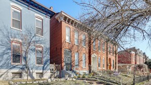 A row of townhouses with a stone pathway leading to the entrance, a small garden area, and a clear blue sky. - Downtown St. Louis Near Arch & Busch Stadium (St. Louis)