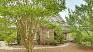 A brick house with a porch, surrounded by trees and a landscaped yard. - 2 Mi to Pinehurst Resort: Spacious Golf Getaway! (Pinehurst)