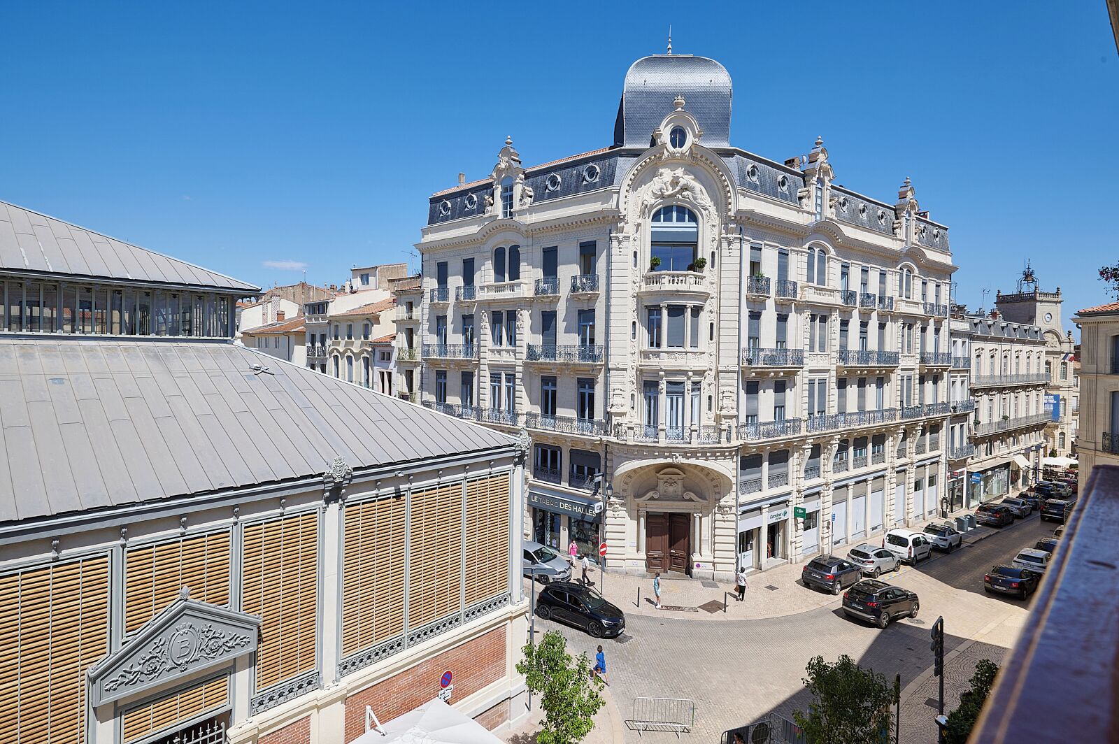 A historic building with ornate architecture, multiple balconies, and a central entrance.
