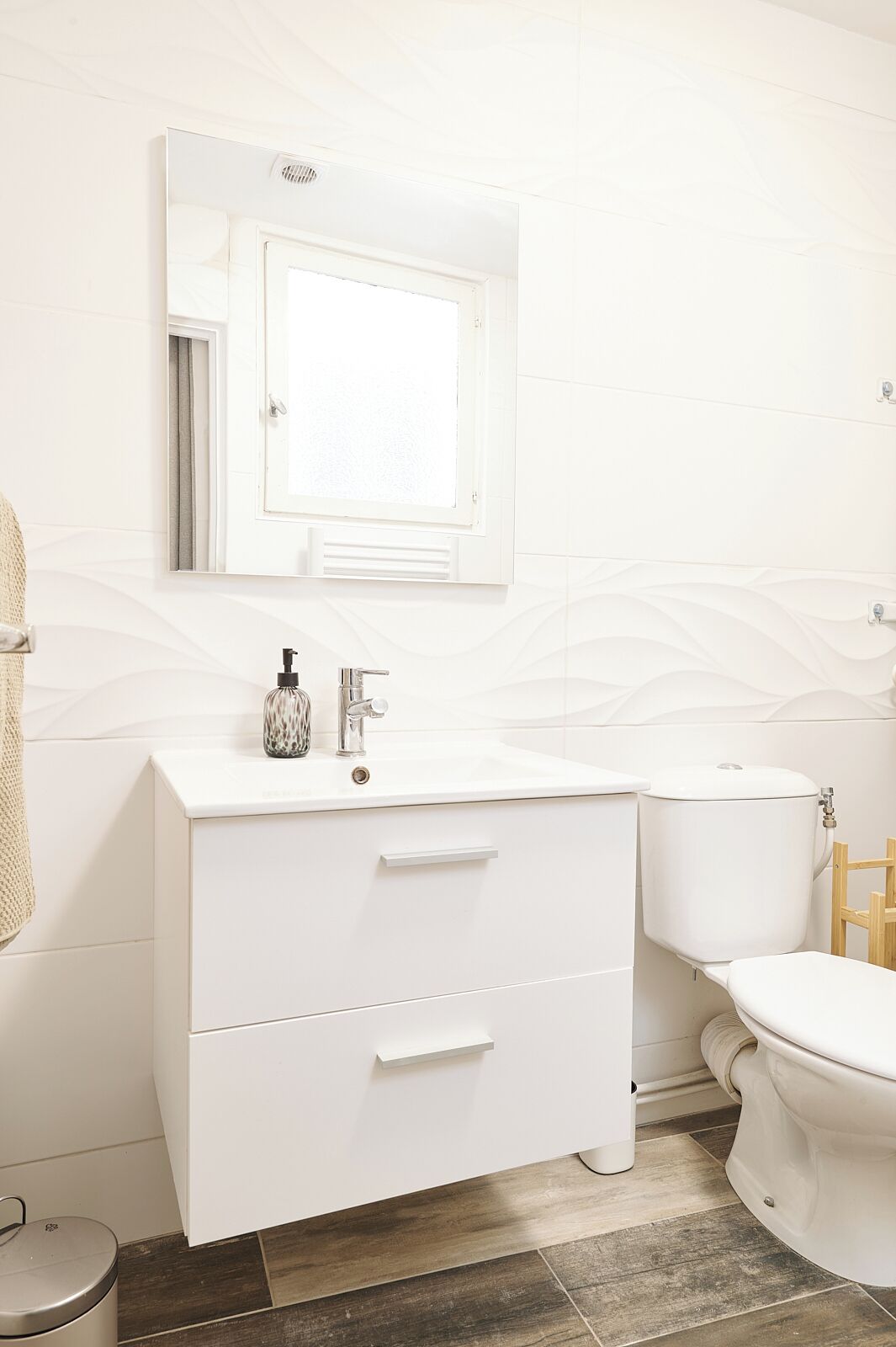 Ein modernes Badezimmer mit einem weißen Waschtisch, einer Toilette und einem Bidet.