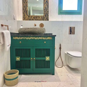 A bathroom with a green vanity, a white toilet, a shower, and a mirror with a wooden frame. - Villa Verde Sidi Bou Saïd (Sidi Bou Said)