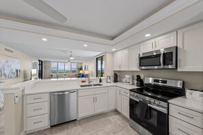 Fridge, microwave, oven, stovetop - 1st-Floor Oceanfront Corner Unit 2BR/2BA | Gulf Views | Large Lanai + Courtyard Patio | Walk to Beach in seconds! (Sanibel Island)