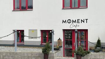 A building with a sign reading "MOMENT Café".