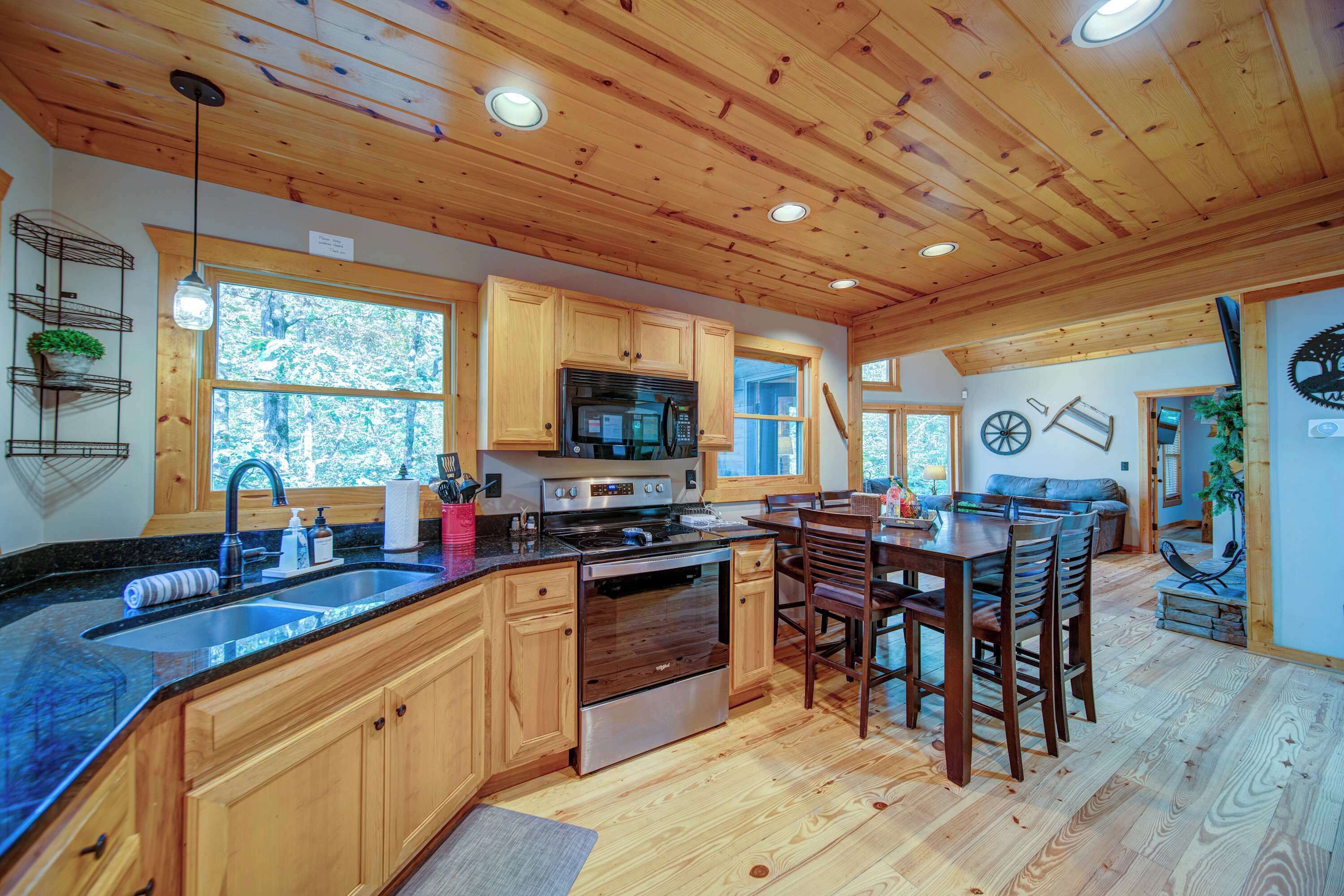 A spacious kitchen with wooden cabinets, a large island, and a dining area with a table and chairs.