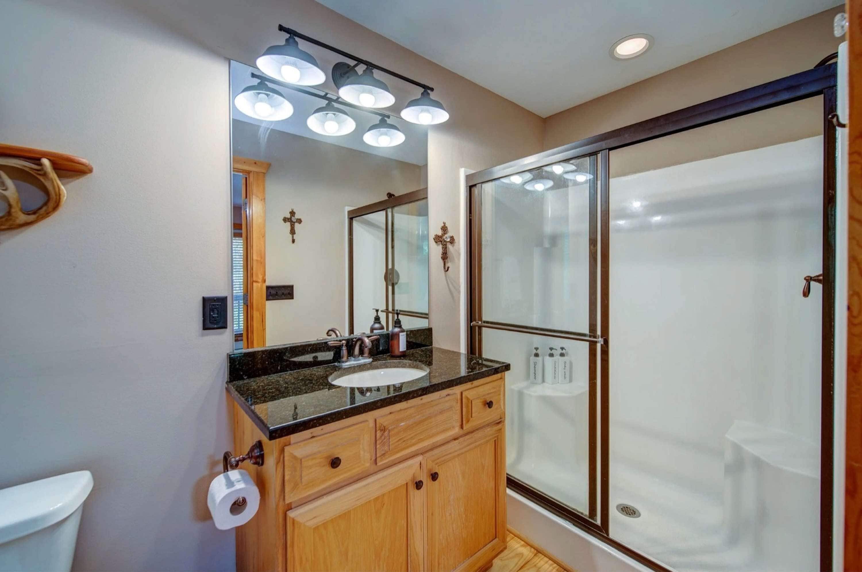 Une salle de bain moderne avec un meuble-lavabo, un évier et une douche.