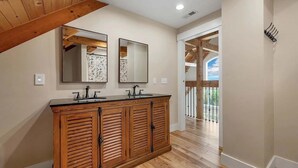 A bathroom with wooden cabinetry, two sinks, and a large mirror. - Huge Luxury Home, Hot Tub, Movie Theater, Mountain Views (Campton)