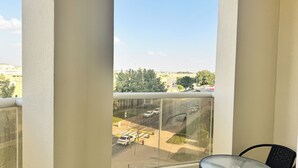 A balcony with a clear view of a road and surrounding buildings. - Spacious 2BR Apartment ,3 Bathrooms ,Near Mall (Abu Dhabi)