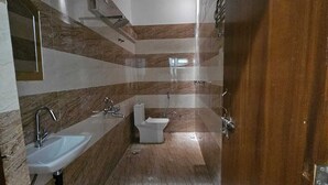 A modern bathroom with a sink, toilet, and shower area. - Relax With Ramayana (Ayodhya)