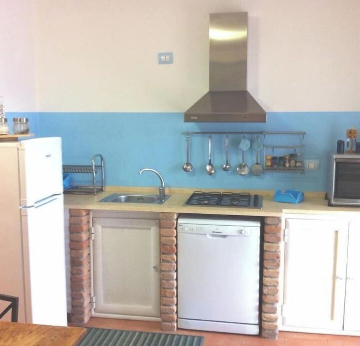 A compact kitchen with a dishwasher, a sink, and a stove.