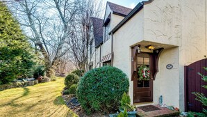 A two-story house with a front door decorated with festive ornaments, a well-maintained lawn, and a brick pathway leading to the entrance. - Highland Ave (Norwalk)