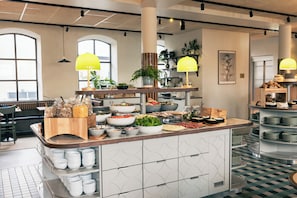 A buffet setup with various food items and a counter with plates.
