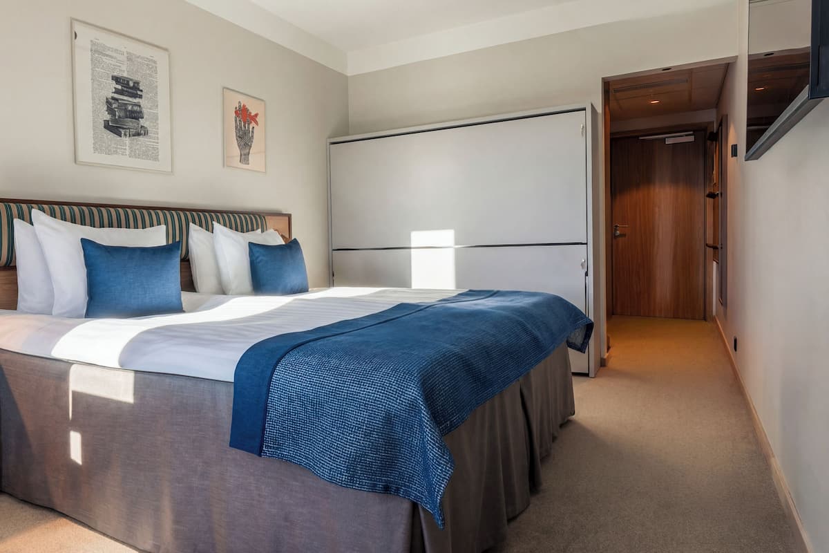 Hypo-allergenic bedding, desk, laptop workspace, blackout drapes